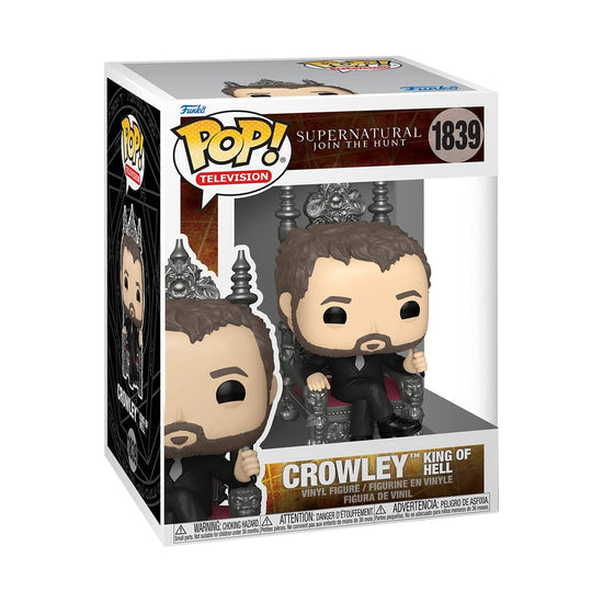 A cardboard box with a transparent front, containing a bobblehead figure depicting the character Crowley, sitting on the silver throne of Hell.
