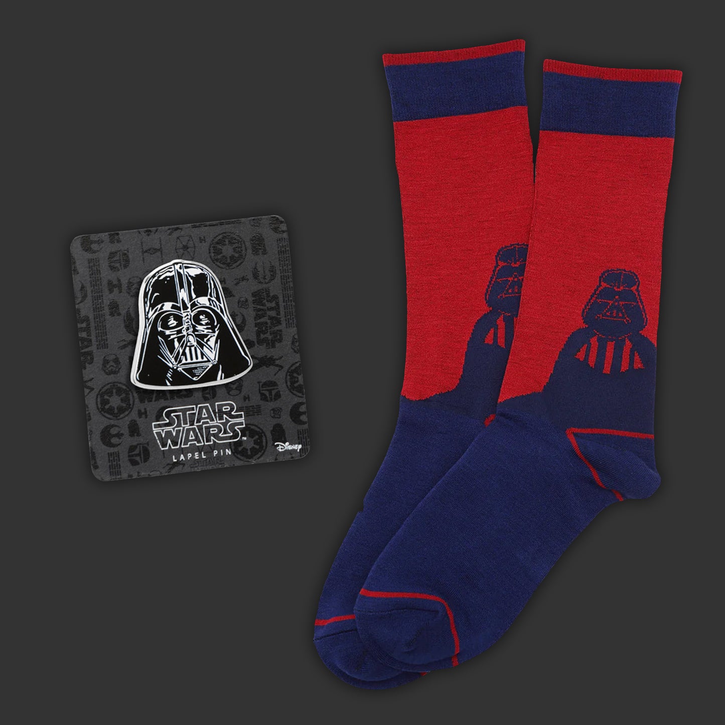 Red and blue socks with Darth Vader design and a matching lapel pin on a dark background