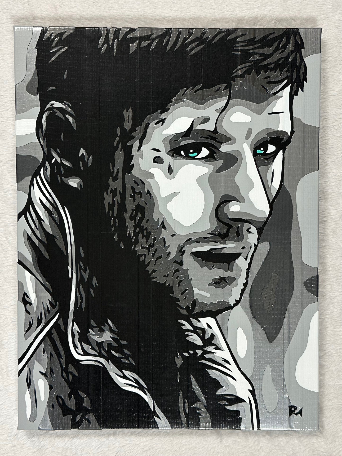 A black and white image of Dean Winchester, created with multiple shades of duct tape, on a white background