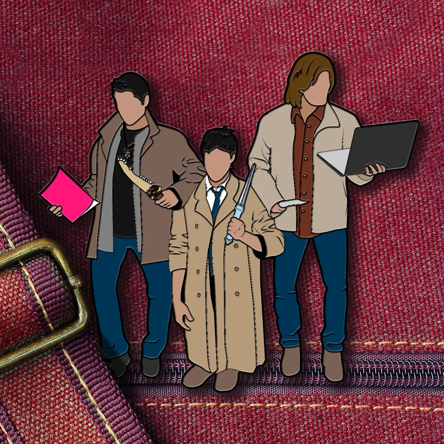 A pin depicting the three main characters from the TV series "Supernatural," but with the actors dressed in each others' costumes. In the center is Jared as Castiel, on his knees to appear shorter. Yellow text at the bottom says "Definitely team free will."