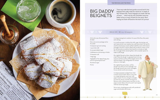 A two-page spread from the book. On the left is a plate of beignets on a plate, covered in powdered sugar. Around the plate are a mug of coffee, a glass of water, and a jar of honey. On the right is a recipe for Big Daddy Beignets.