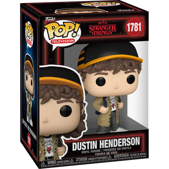 A cardboard box with a transparent front, containing a bobblehead figure depicting Dustin Henderson from the TV series Stranger Things. He is wearing a Hellfire Club t-shirt under a tan raincoat, with a striped hat on his head.