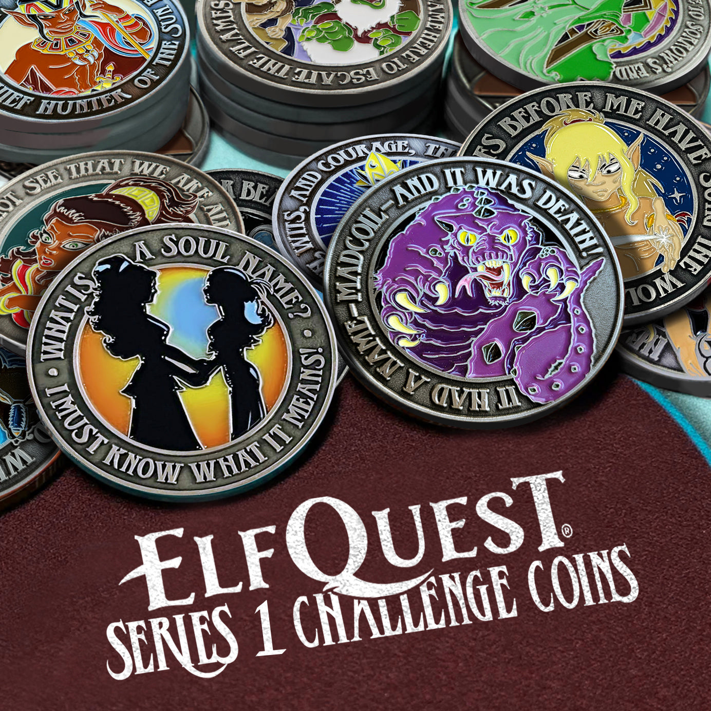 A photo of a series of ElfQuest-themed metal challenge coins laid out/stacked like poker chips. The coins are on a maroon, textured card table that reads "ELFQUEST SERIES 1 CHALLENGE COINS" in white font.