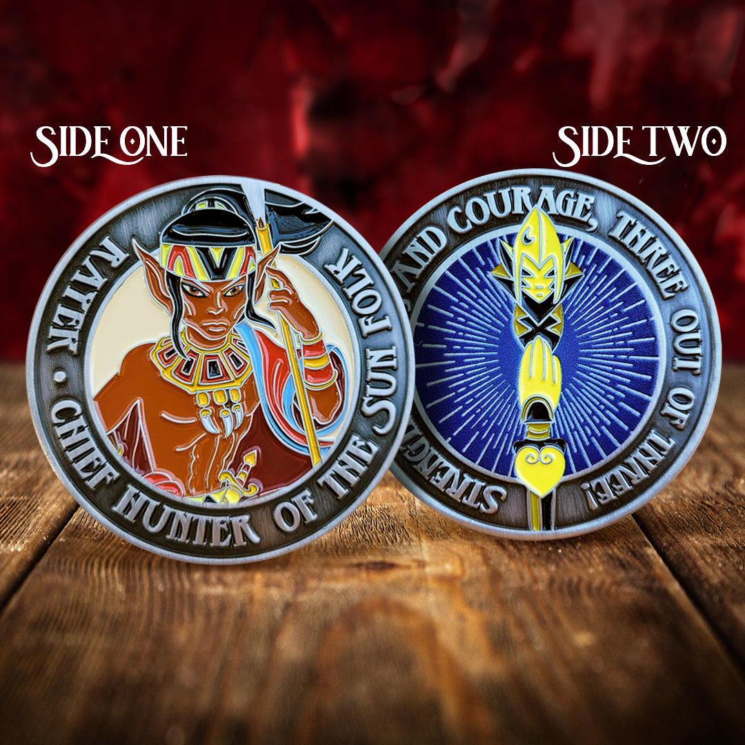 Front and back images of a brass challenge coin, on a wood table. The front depicts an elf in with a yellow headband, wearing a collar with multi-colored squares. The elf is carrying a spear, and a red and blue robe is draped over his arm. Raised text around the edge reads "Rayek, chief hunter of the sun folk." The back of the coin shows a yellow spear tip on a blue backgrounf. Raised text around the egde reads "Strength, wits, and courage, three out of three!"