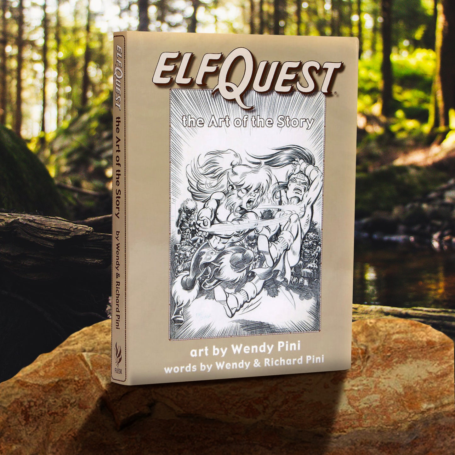 A copy of ElfQuest: The Art of the Story (art by Wendy Pini, words by Wendy & Richard Pini) decpited in a forest environment. The cover has sketch-art-style ElfQuest characters in black and white and a tan border. 
