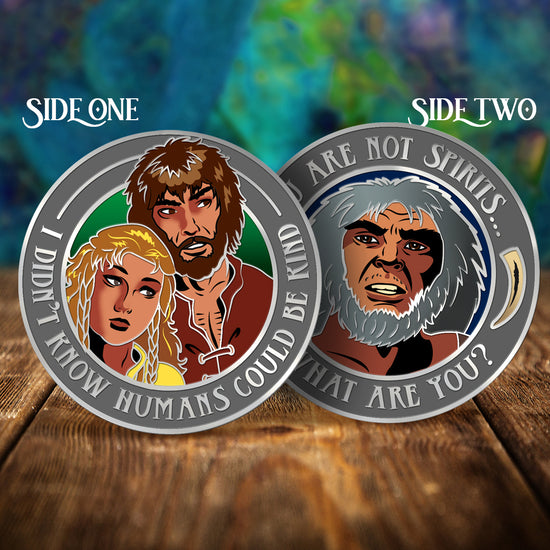 Two sides of a coin with ElfQuest illustrations and text on a wooden surface and colorful background