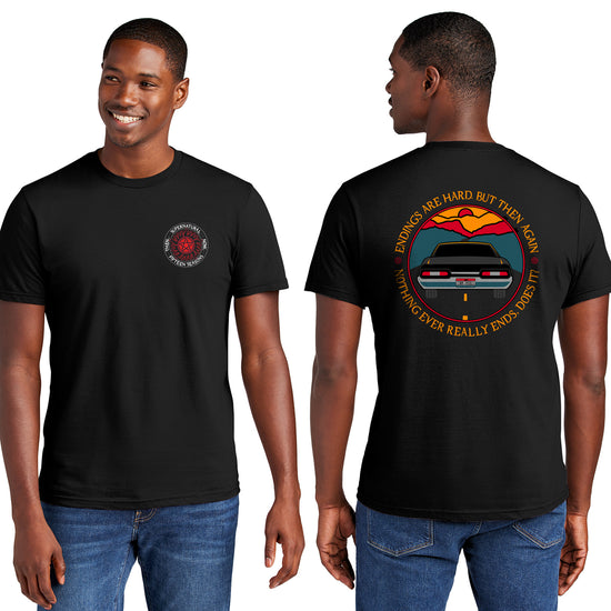 Front and back views of a male model wearing a black t-shirt. On the front is the anti-possession symbol in silver and red. Around the edge of the symbol, white text says "Supernatural, Fifteen Seasons. Then... Now..." The back of the shirts depicts the tail end of a black 1967 Chevy Impala driving on a black road toward a sunset. Around the edge is yellow text saying “Endings are hard, but then again nothing ever really ends, does it?"