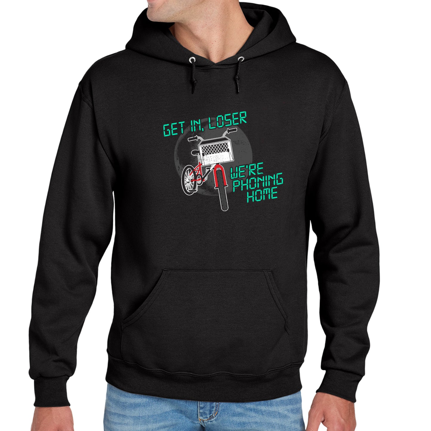 A model in a black hoodie against a white background. On the front is a drawing of a red bike with a basket in the front. Above and below the bike is green text saying "Get in, loser, we're phoning home," stylized to look like text from old electronics.