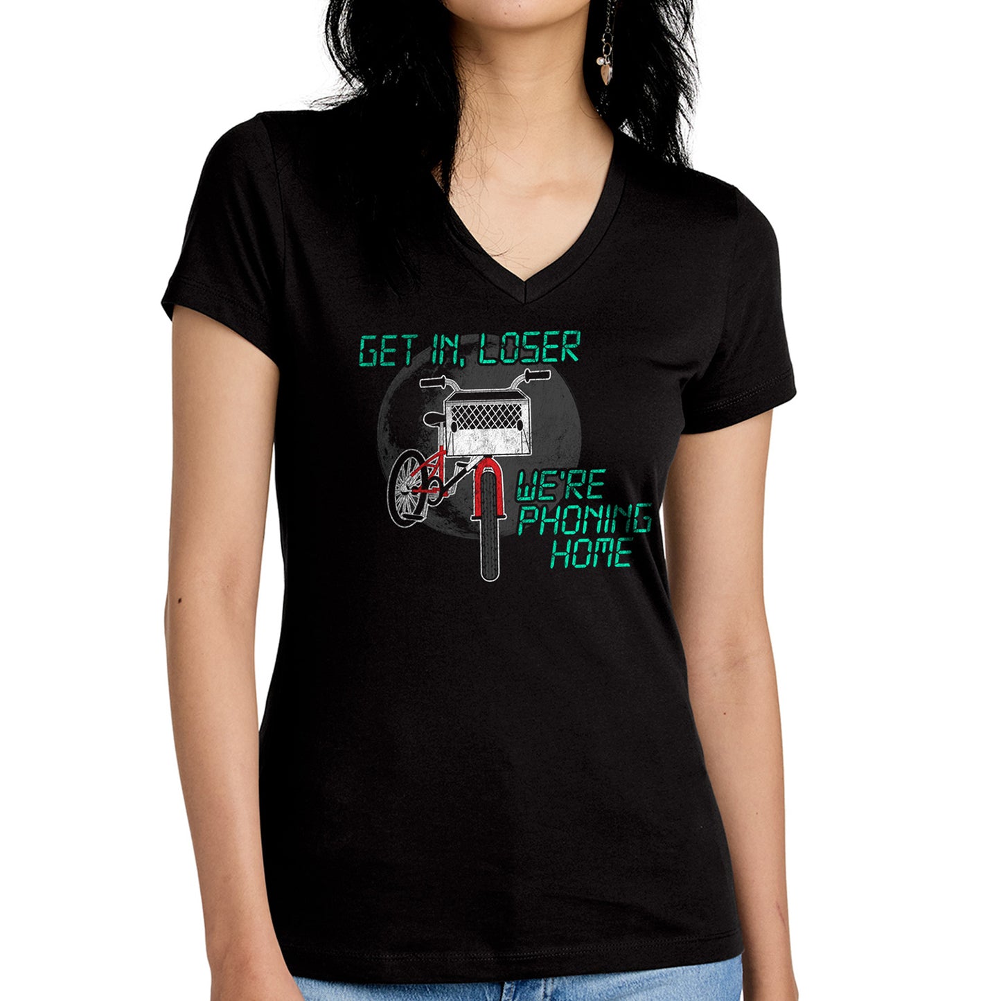 A model in a black tee shirt against a white background. On the front is a drawing of a red bike with a basket in the front. Above and below the bike is green text saying "Get in, loser, we're phoning home," stylized to look like text from old electronics.