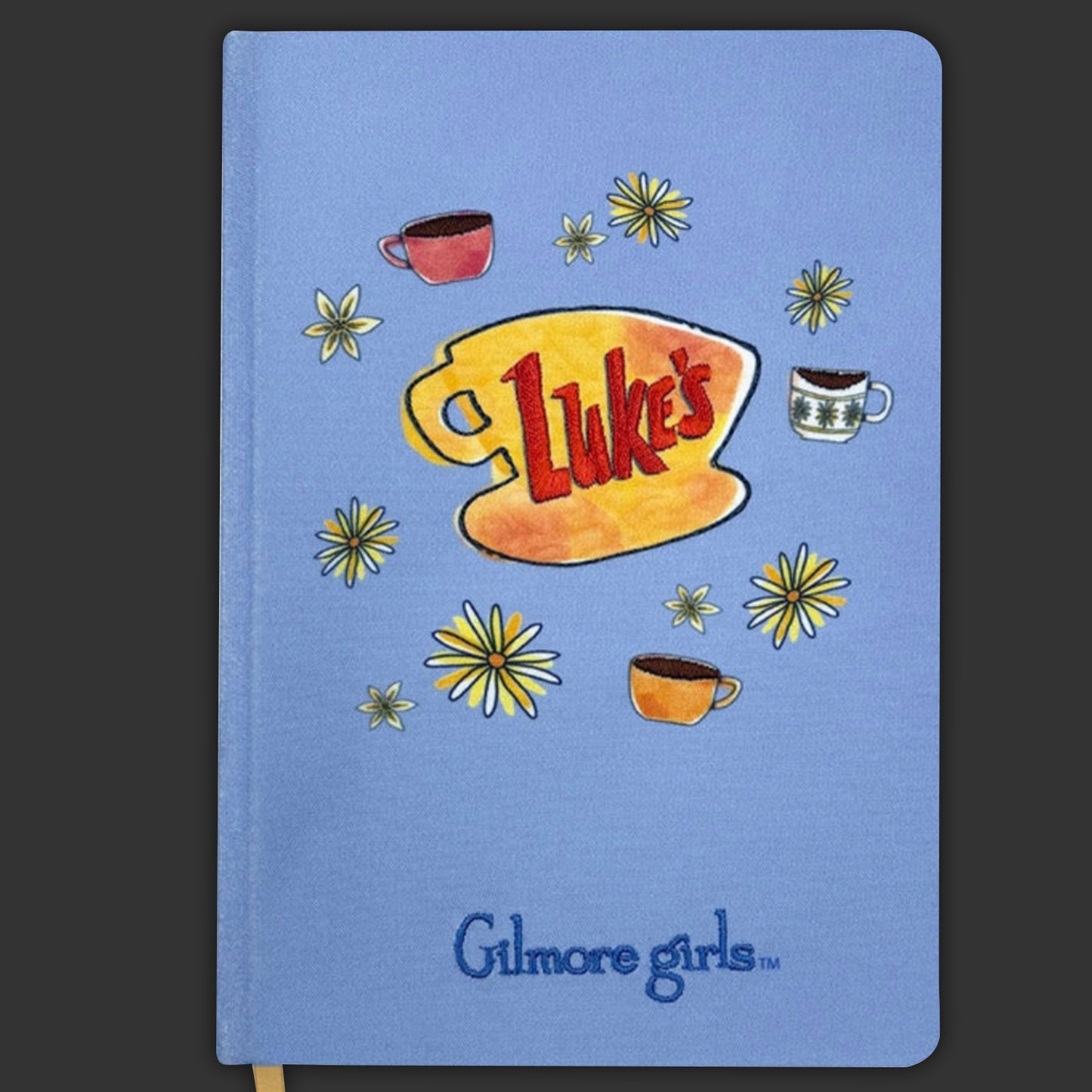 Notebook with 'Gilmore Girls' branding and 'Luke's' logo on a blue background