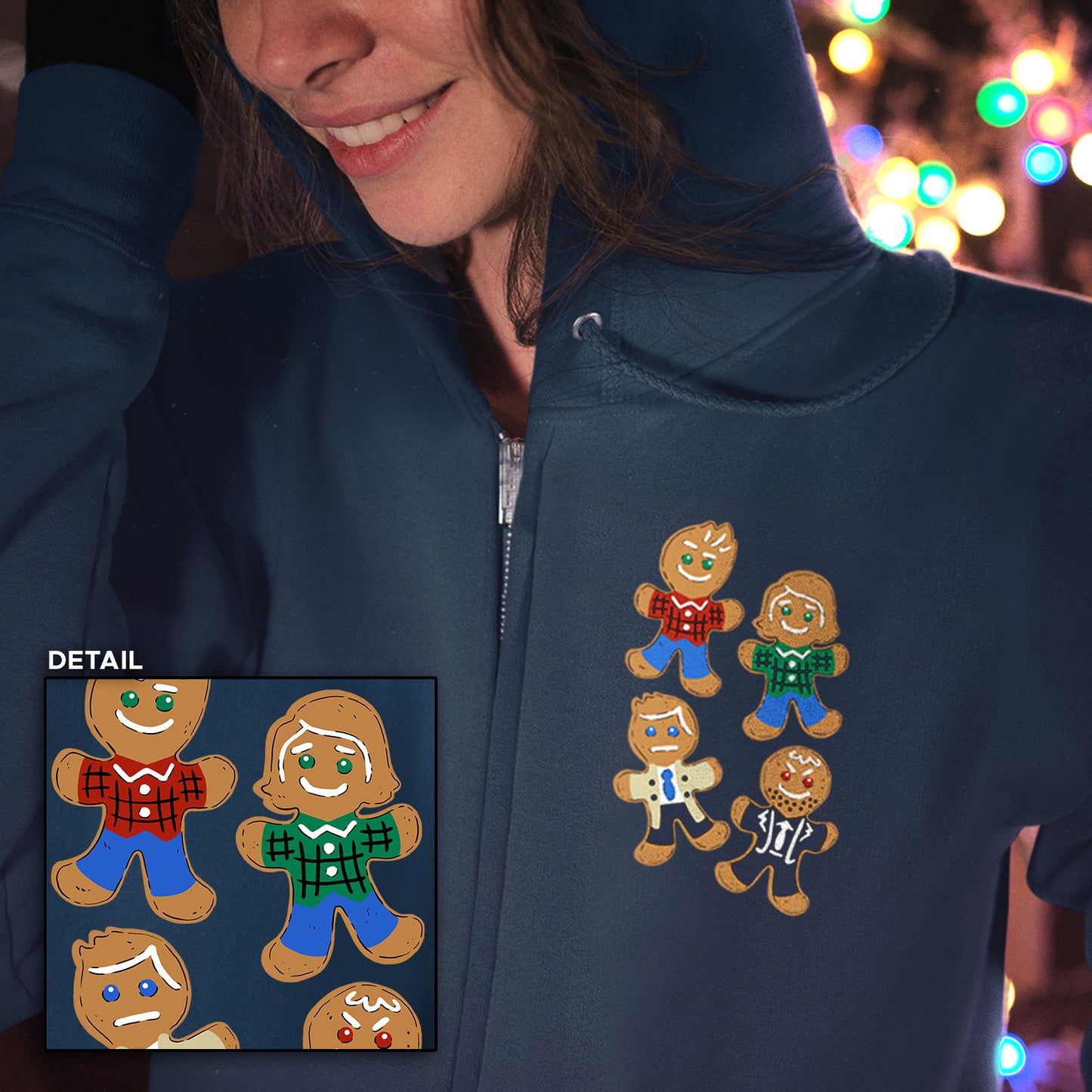 Person wearing a navy hoodie with gingerbread men designs, colorful lights in the background