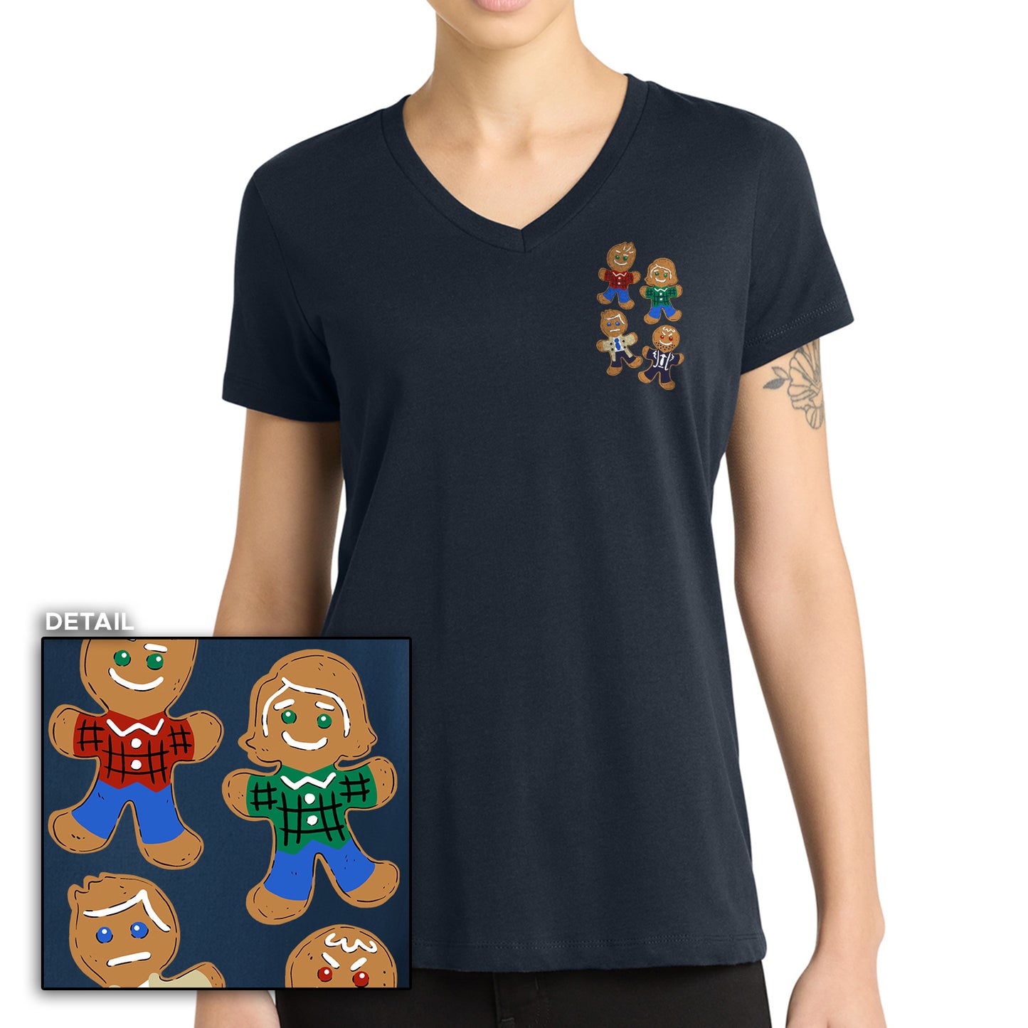Person wearing a navy blue t-shirt with gingerbread people design on a white background