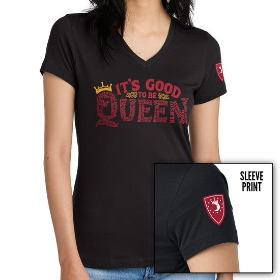 Black t-shirt with 'It's Good to be Queen' text and a logo on a white background. The text is comprised of various words shaping the word "Queen." An inset image at the bottom right shows a red shield-shaped emblem on the sleeve. The emblem has a white crescent moon wearing a crown.