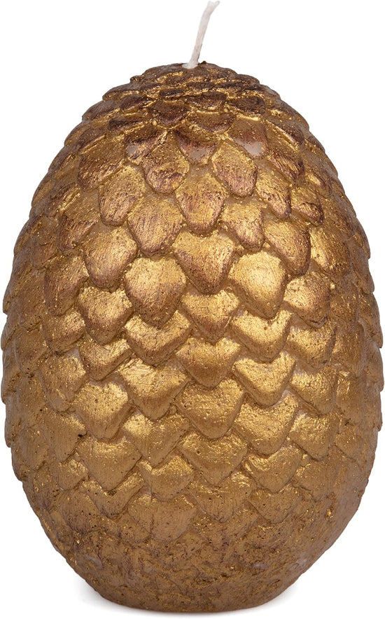 A gold, egg-shaped candle with scales around the outside.