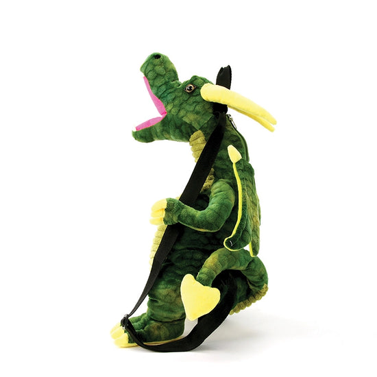 A dragon-shaped backpack in shades of green, against a white background. The dragon has green wings, and a red mouth, with black straps at the back.