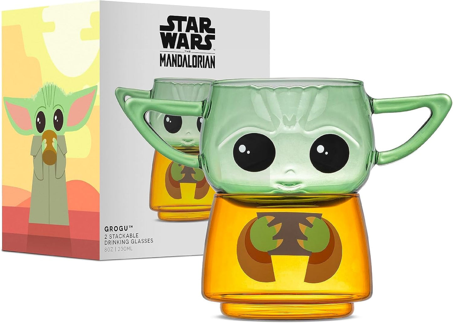 Two small drinking glasses stacked on each other against a white background. The two glasses combined depict the character Grogu from the Star Wars series The Mandalorian. The top glass has two handles shaped as his ears. Next to the glasses is a cardboard box, depicting the set.