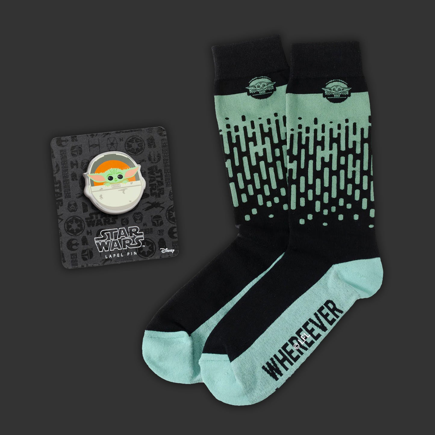 Pair of socks with 'WHEREVER' text and a Star Wars themed lapel pin on a dark background