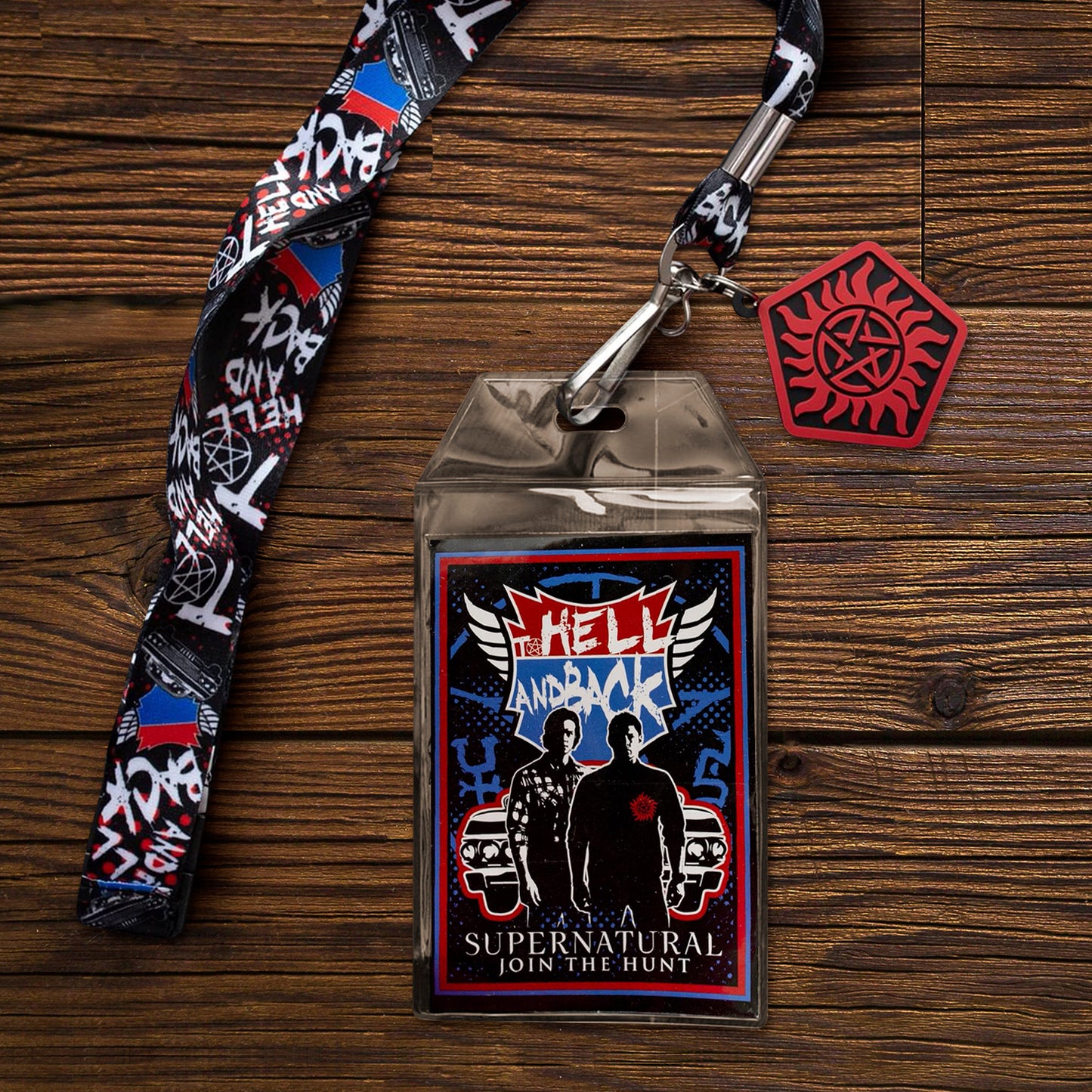 Supernatural-themed lanyard with badge holder on a wooden surface