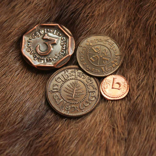 Load image into Gallery viewer, A set of four copper coins from The Hobbit, sitting on a pile of light brown straw. Around the edges of each coin are stamped symbols, taken from the Hobbit language in the Lord of the Rings series.
