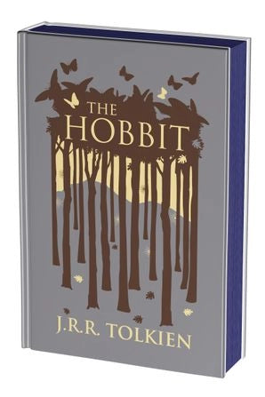A grey hardcover book on a white background. The front cover depicts a minimalist drawing of a forest in brown. Gold text says "The hobbit."