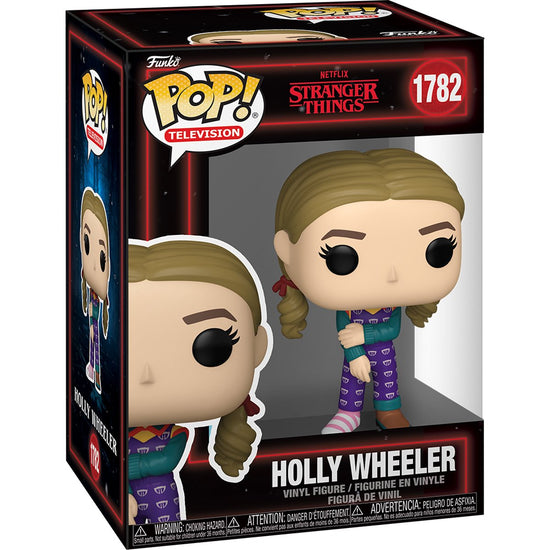 A cardboard box with a transparent front, containing a bobblehead figure depicting Holly Wheeler from the TV series Stranger Things. She is wearing a purple jumpsuit, with one brown shoe and one pink and white striped sock.