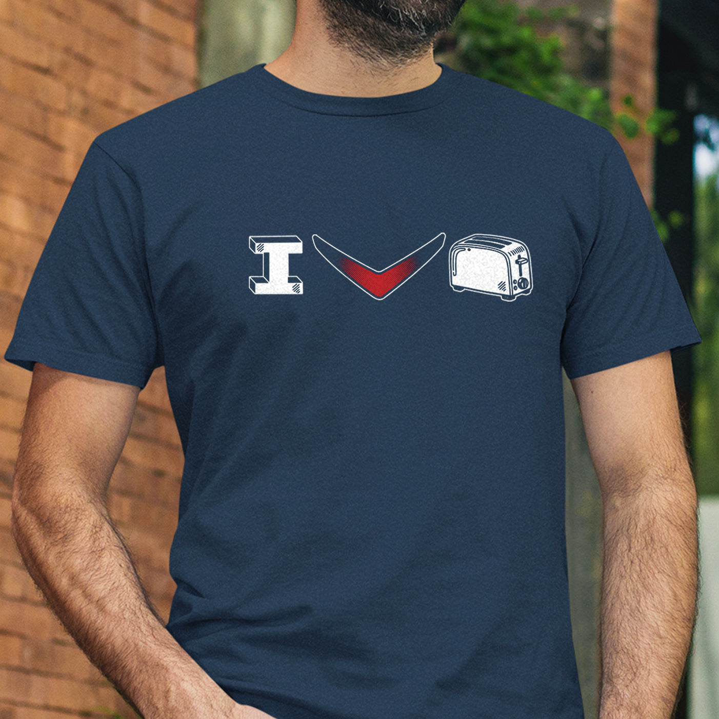 A man wearing a navy blue t-shirt with a graphic print that reads 'I Heart Toaster" spelled with a red chevron and n image of a toaster