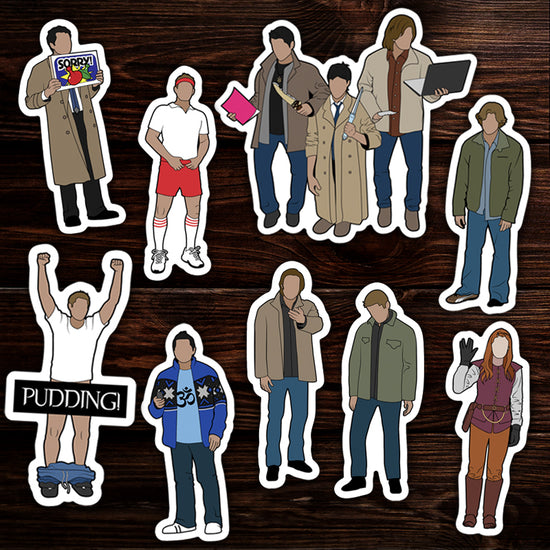 A collection of stickers based around the series Supernatural, on a wooden background.
