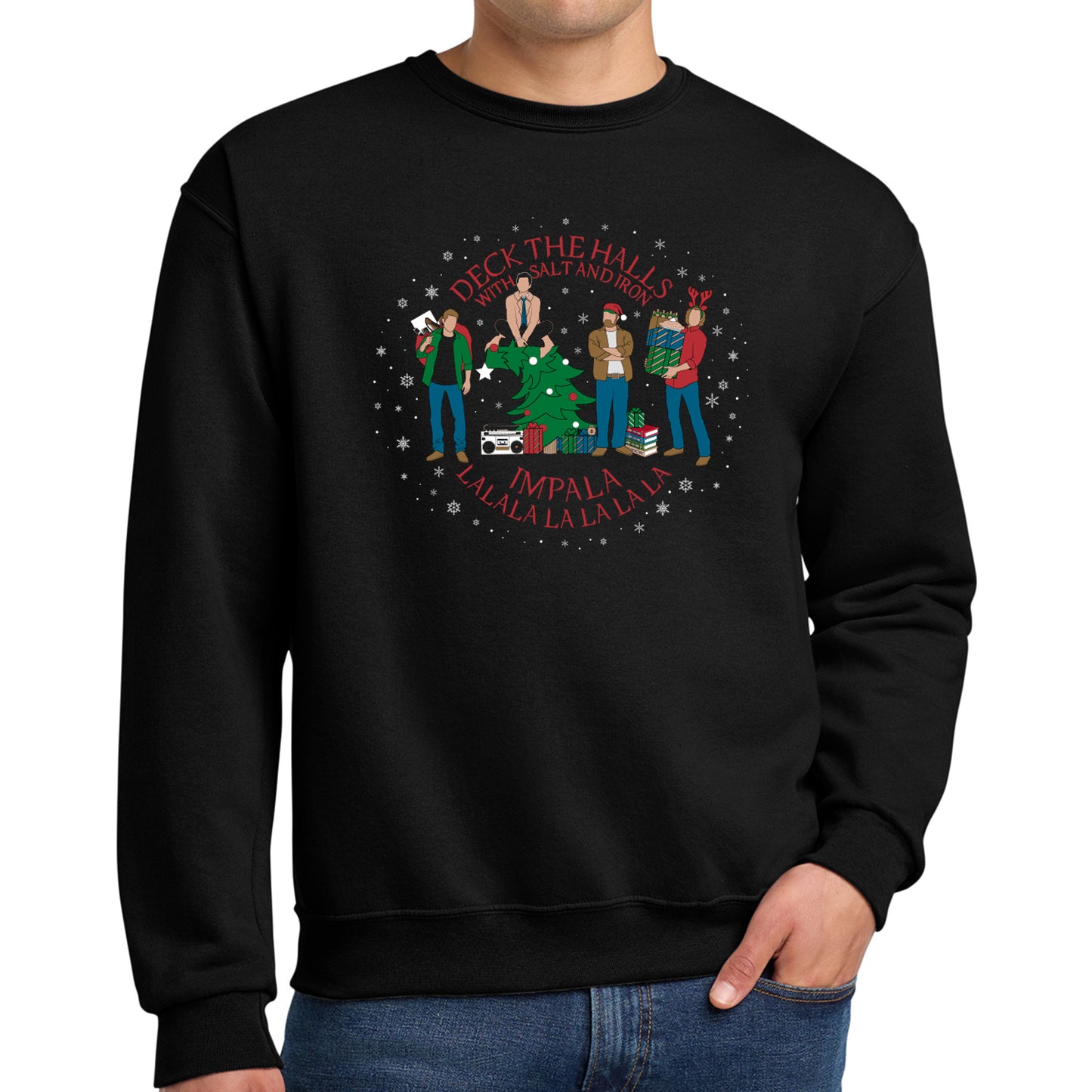 A model in a black sweatshirt, with a Supernatural themed holiday design on the front. Red text says "deck the halls with salt and iron. Impala lalala la la lala."