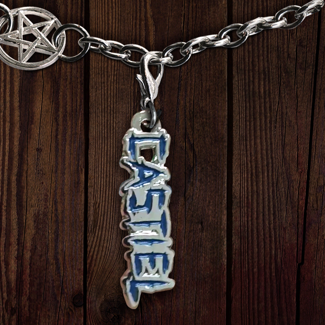 A metal charm on a linked bracelet, against a dark wooden background. The charm depicts the name Castiel in blue. At the top left is a charm with the anti-possession symbol at its center.