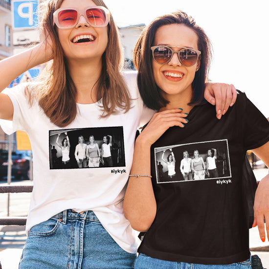 Two female models side by side. The left model is wearing a white T-shirt, the right model is wearing a black T-shirt. Both shirts have a black and white image of characters from the TV series "The L Word." Under the image is the hashtag #ifkyk