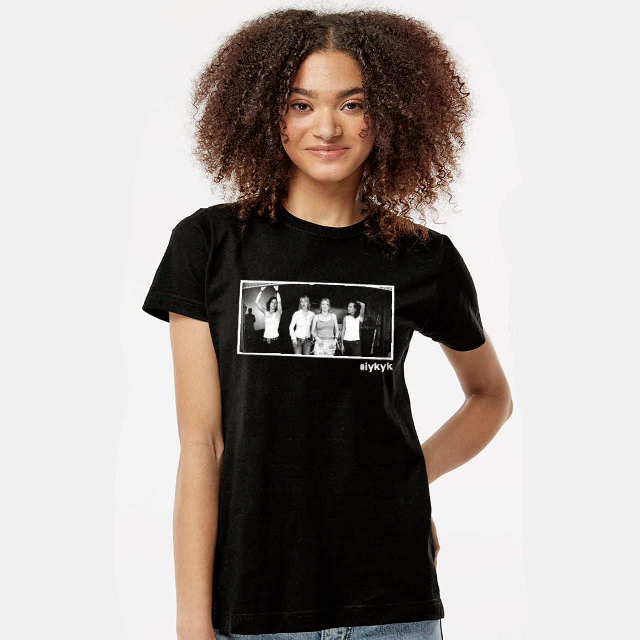 A female model wearing a black T-shirt. On the front is a black and white image of characters from the TV series "The L Word." Under the image is the hashtag #ifkyk