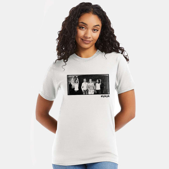 A female model wearing a white T-shirt. On the front is a black and white image of characters from the TV series "The L Word." Under the image is the hashtag #ifkyk