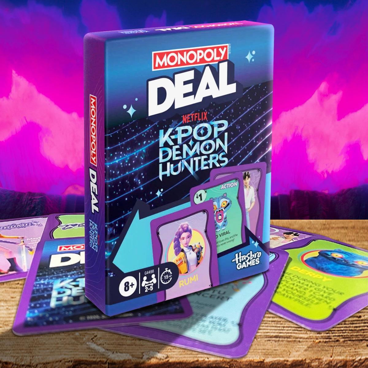 Monopoly Deal Netflix K'Pop Demon Hunters game box with cards on a wooden surface and colorful background