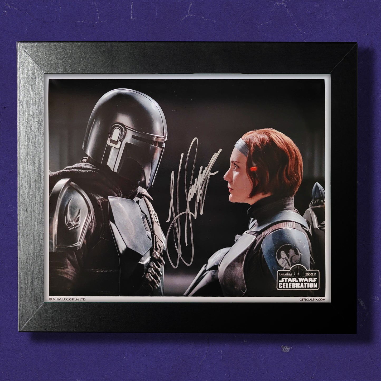 A framed image of Bo Katan and Dink Djarin from The Mandalorian, signed by actor Katee Sackhoff
