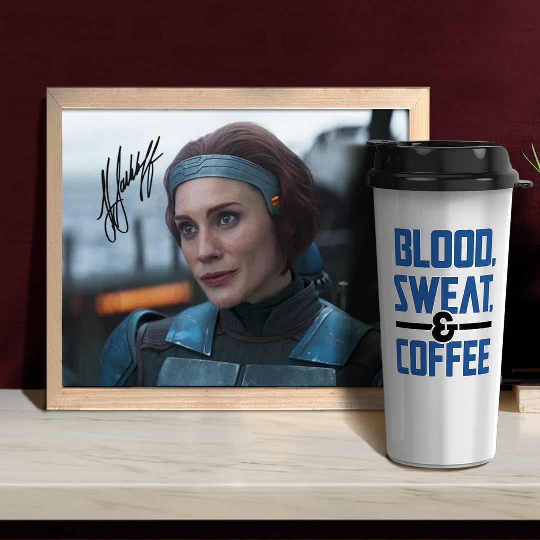 A framed picture of Katee Sackoff's character from The Mandalorian TV series, with her face visible. In the corner of the image is Katee's autograph. In front of the framed picture is a white travel mug with blue text that says "blood, sweat & coffee."