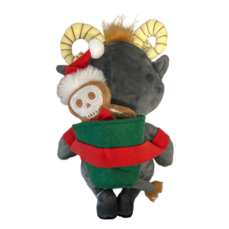 Rear view of a grey plushie depicting the mythological figure Krampus. At the top of his head are yellow horns and patches of brown hair. Across his back is a green bag holding a small gingerbread figure wearing a santa hat.