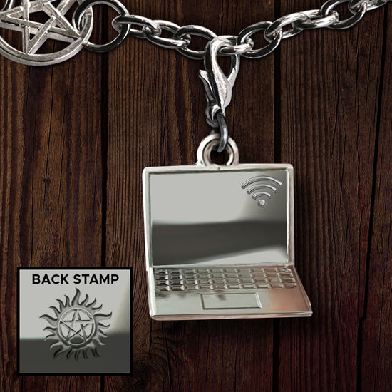 A silver charm depicting a laptop with a wifi symbol on the screen, against a wooden background. Inset at the bottom left is an image of an Anti-possession symbol, stamped on the back of the charm.