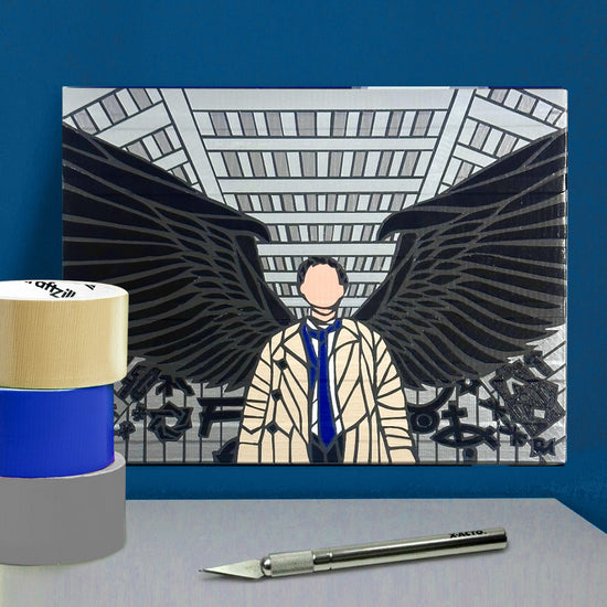 A grey and black poster against a dark blue wall. The poster depicts the angel Castiel, black wings outstretched behind him, standing in front of a grey wall with dark grey sections." Next to the poster are rolls of colored duct tape and cutting tools.