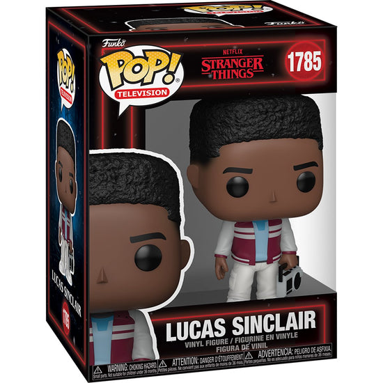 A cardboard box with a transparent front, containing a bobblehead figure depicting Lucas Sinclair from the TV series Stranger Things. He is wearing white pants and a maroon jacket, and carrying a radio in one hand.