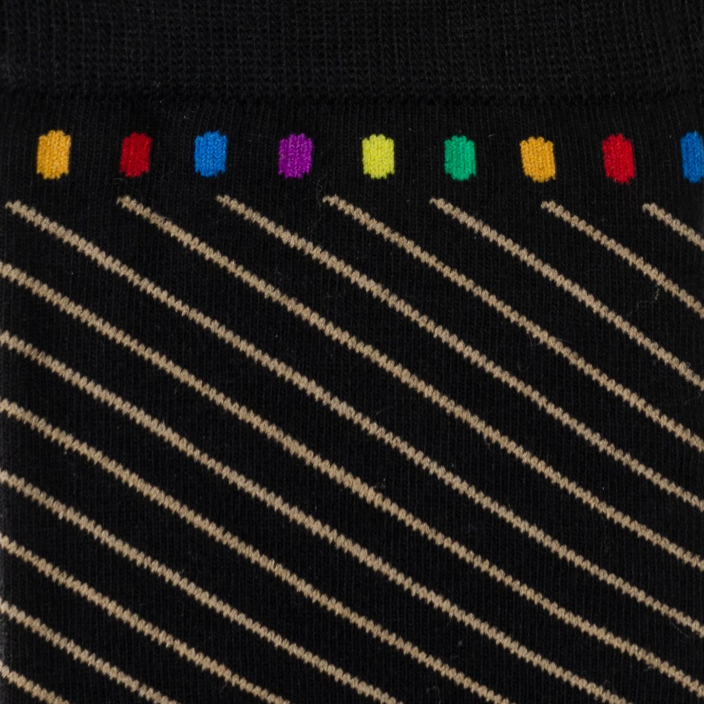 Close-up of a sock with rainbow-colored dots at the top and diagonal lines on a black background.