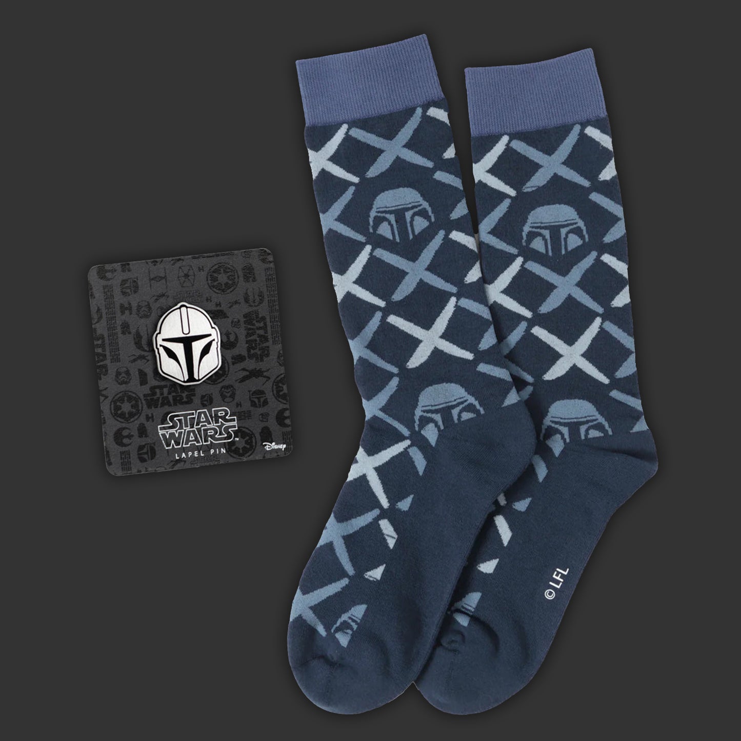 Blue socks with Mandalorian pattern and matching lapel pin on a dark background