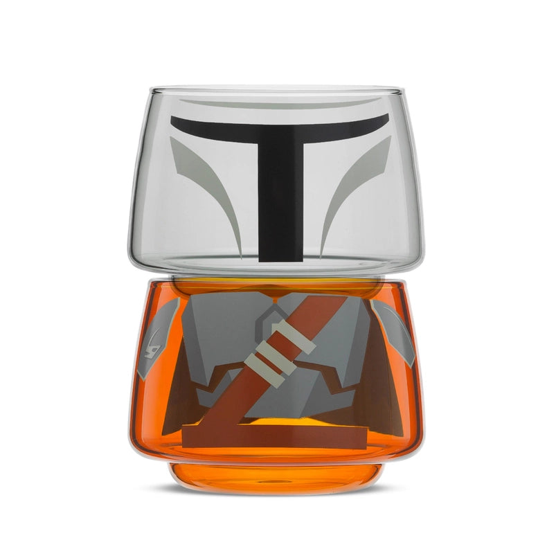 Two small drinking glasses stacked on each other against a white background. The two glasses combined depict the titular character from the Star Wars series The Mandalorian.