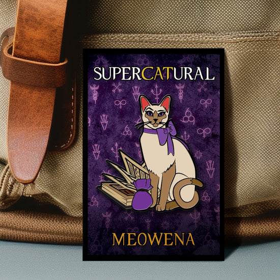 An enamel pin against a beige canvas bag. The pin depicts a Siamese cat with a purple bow around its neck. Next to the cat is a spell book, with a small purple bag in front of it. Behind the cat is a purple background with various magical symbols strewn across it. White and yellow text says "Supercatural: Meowena"