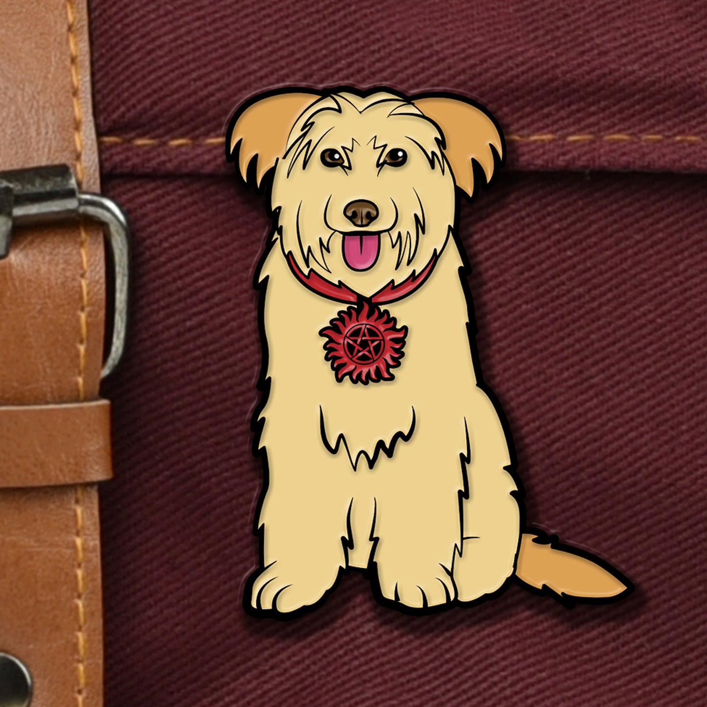 An enamel pin attached to a brown canvas bag. The pin is shaped like a scruffy yellow dog, with a red collar. The collar has a red and black anti-possession symbol attached to the front.