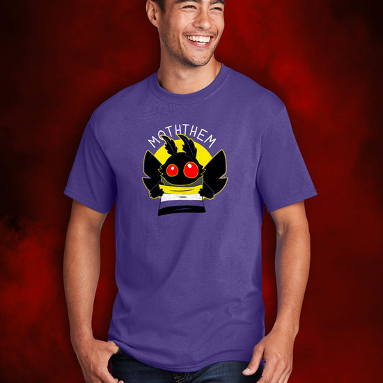 A male model wearing a purple T-shirt. A yellow circle in the center has a black moth head with red eyes, and black wings at the sides. The moth is holding a Non-binary Pride flag, in yellow, purple, white, and black. Above the image is white text saying "MOTHTHEM."  Behind the model is a smoky red background.