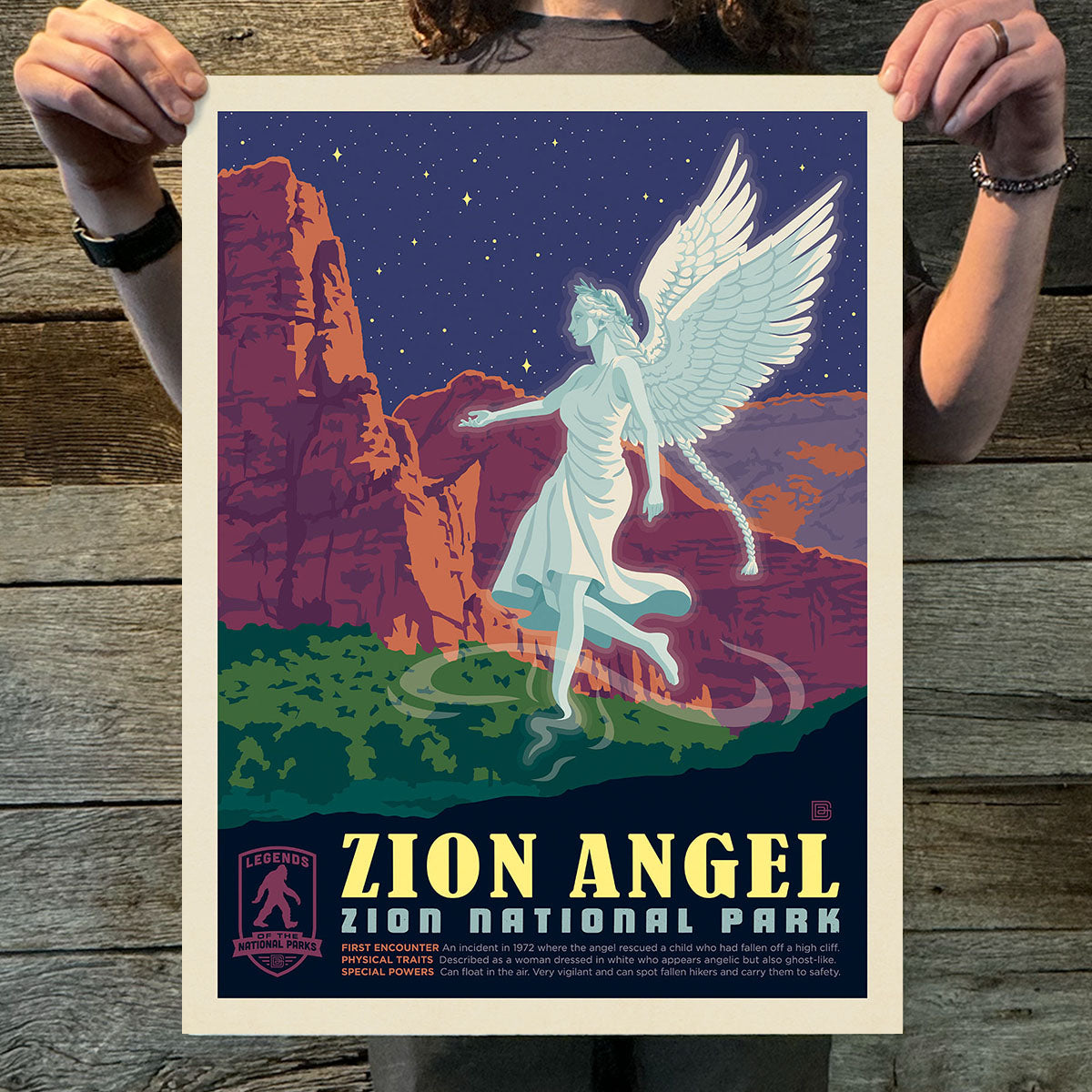 Poster of Zion Angel at Zion National Park held by a person on a wooden surface