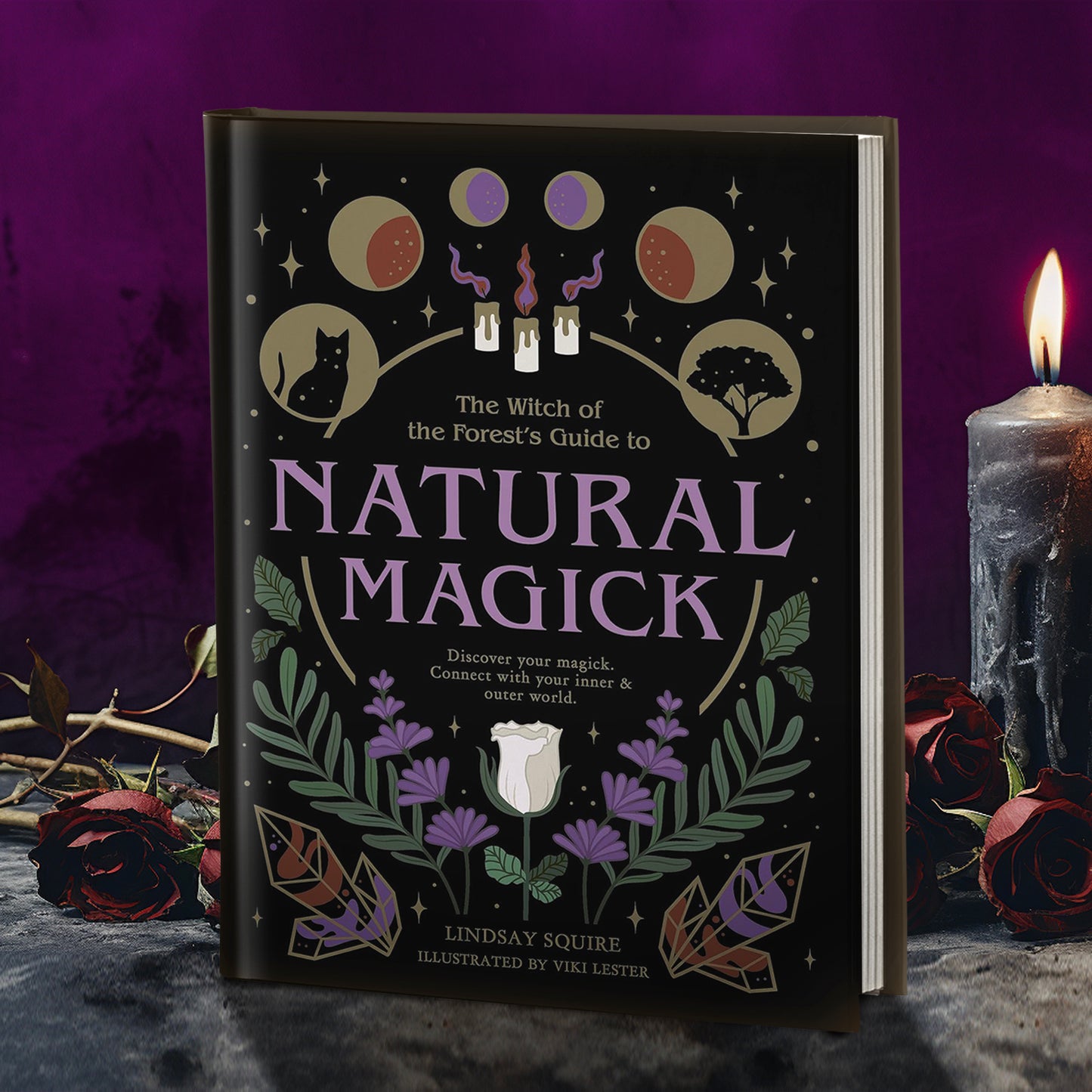 A hardcover copy of "The witch of the forest's guide to natural magick: Discover your magick, connect with your inner & outer world". The cover is black with sage green, forest green, and lavender details.