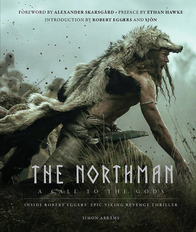 A hardcover book against a white background. The cover depicts a Viking warrior in battle dressed in a wolfskin. White text says "The Northman."