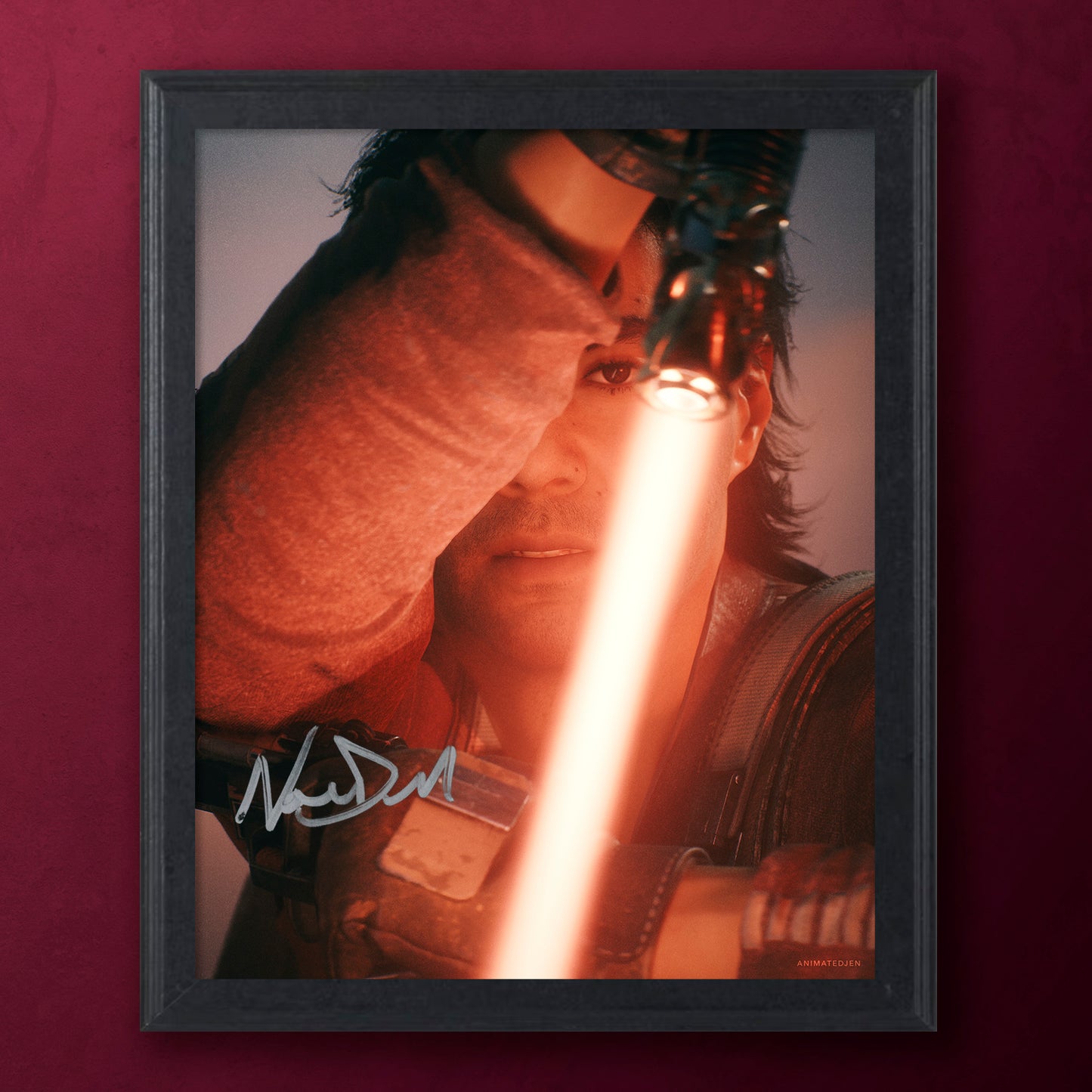 Framed photograph of a character holding a lightsaber with a signature, against a dark background.