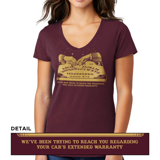 A female model wearing a maroon V-neck shirt, with a gold color image of two hands over a Ouija board. Under the board is gold text saying "We've been trying to reach you regarding your car's extended warranty." A second, smaller image is at the bottom, showing a close-up of the text.